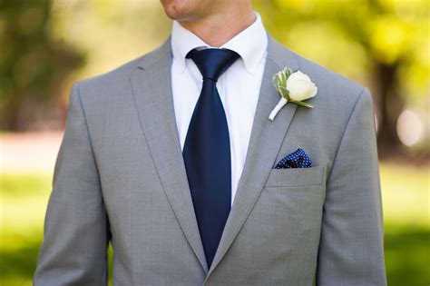 grey suit with navy blue tie.